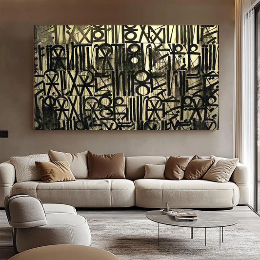 Abstract art piece on a wall above a beige sofa in a modern living room.