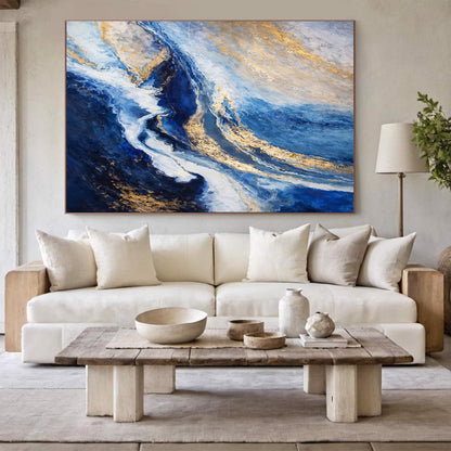 Living room with a large abstract painting above a white sofa, wooden coffee table, and decorative items.