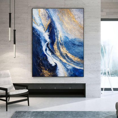 Abstract painting with blue and gold tones in a modern living room setting.