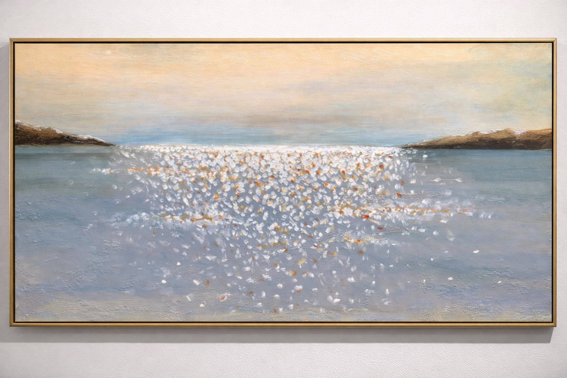 Framed painting of a coastal scene with water and sky.