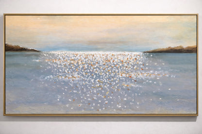Framed painting of a coastal scene with water and sky.