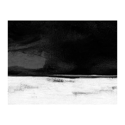 Black and white landscape with a mountainous background and a flat foreground.