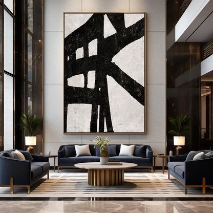 Modern living room with abstract art, dark blue sofa, and wooden coffee table.