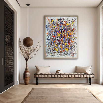 Colorful abstract drip painting displayed in a minimalist entryway above a cushioned bench with modern decor accents.