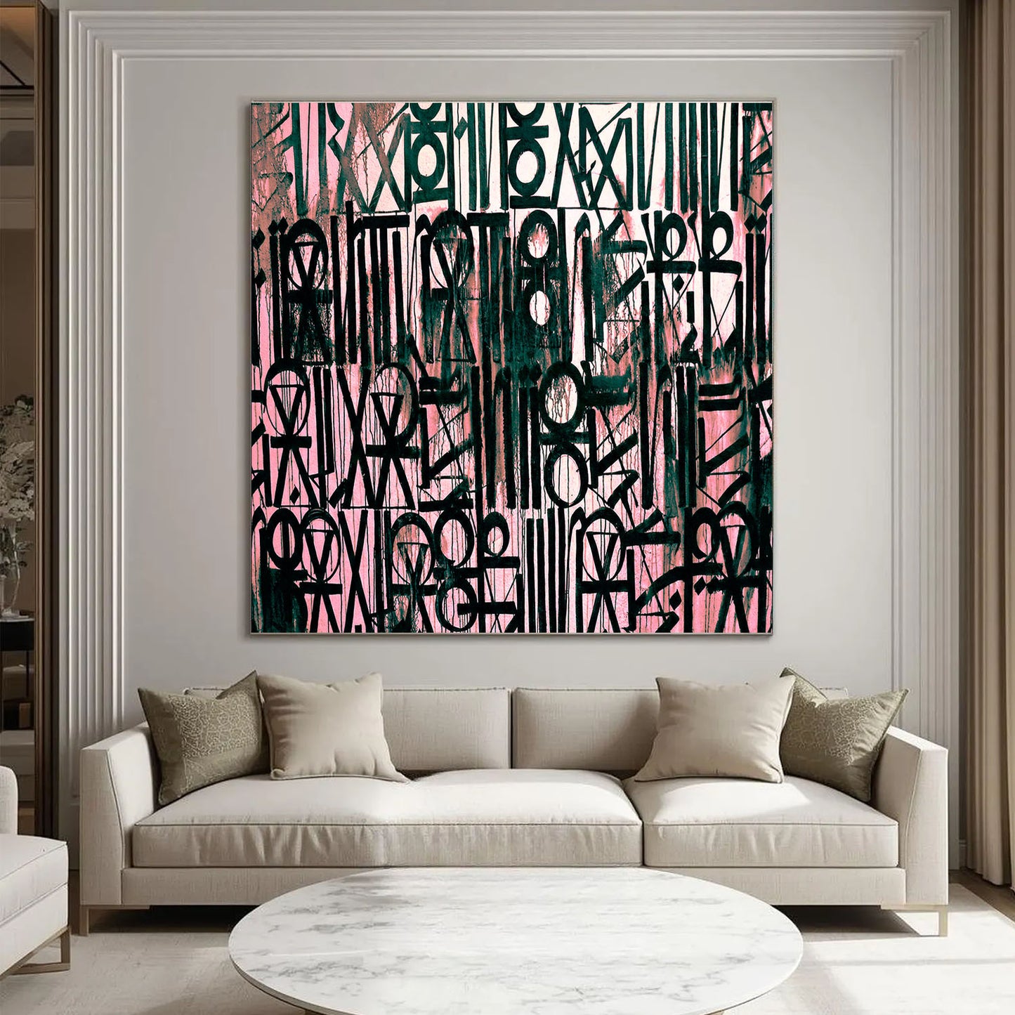 Abstract art piece on a wall above a beige sofa in a living room.