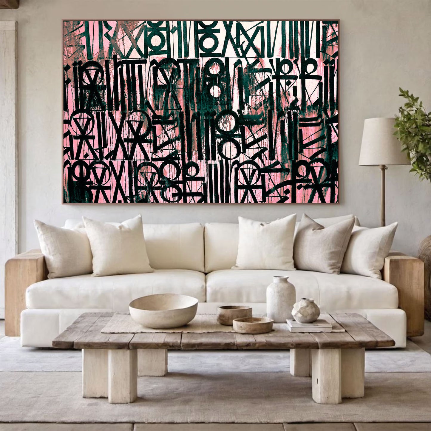 Modern living room with a white sofa, wooden coffee table, and abstract art on the wall.