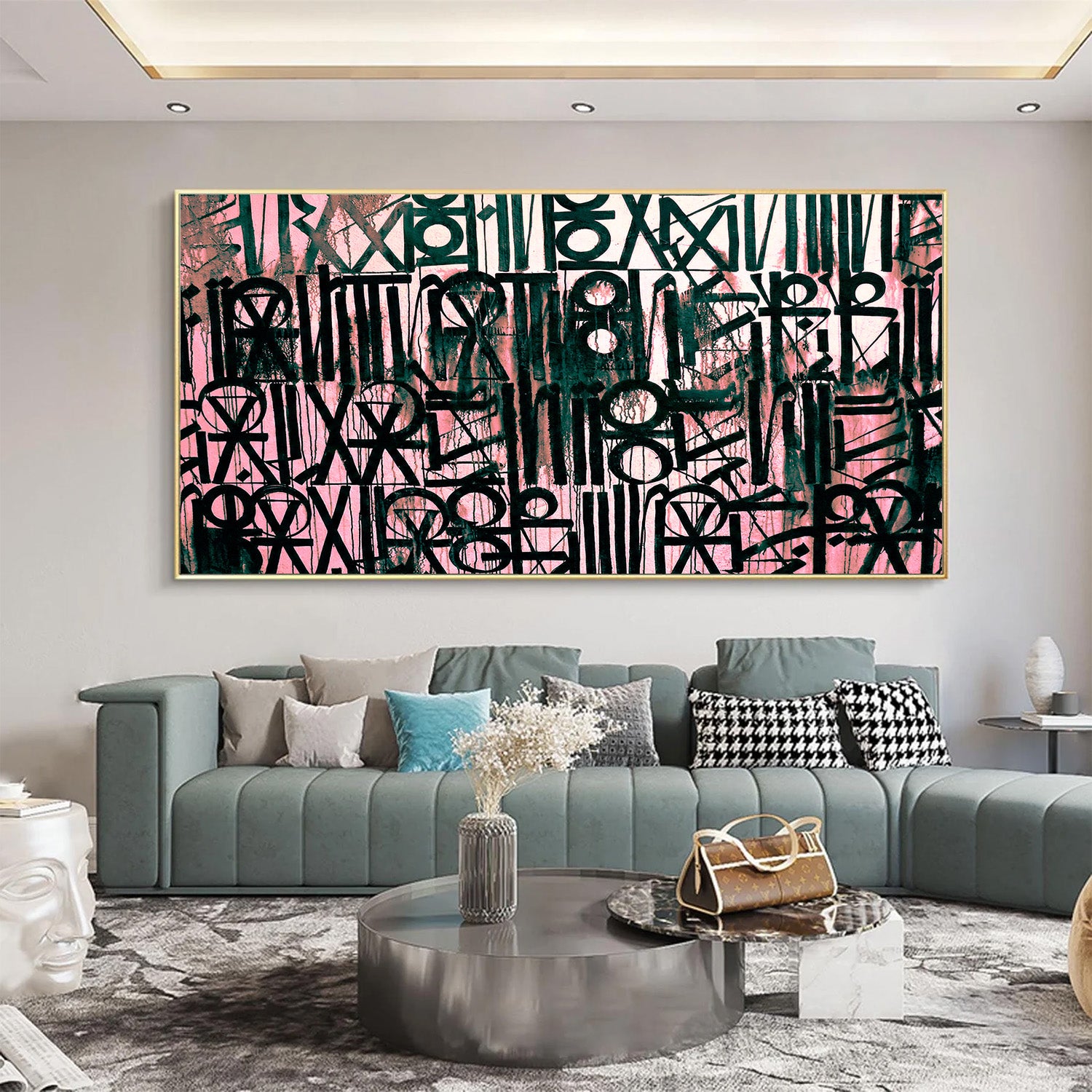 Living room with a large abstract painting on the wall, a gray sofa, and decorative items.
