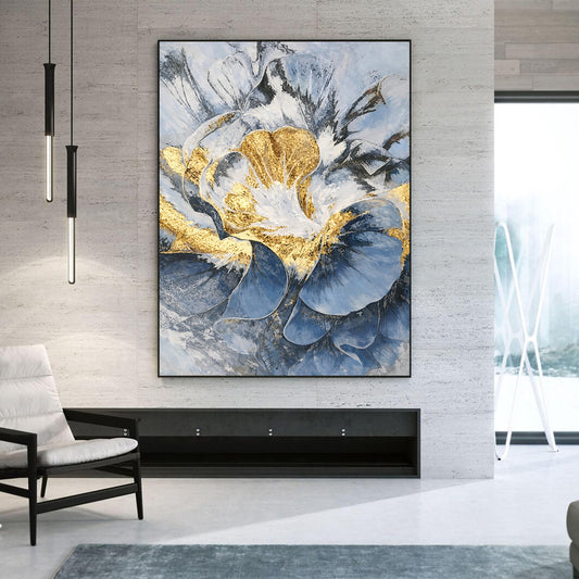 Abstract art piece with gold and blue tones in a modern living room setting.