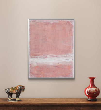 A blush pink abstract artwork displayed on a wall above a wooden shelf with a decorative sculpture on the left and a red vase on the right.