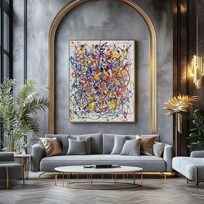 Abstract expressionist wall art with bold splatter colors displayed above a grey sofa in a luxury living room with gold arch detailing.