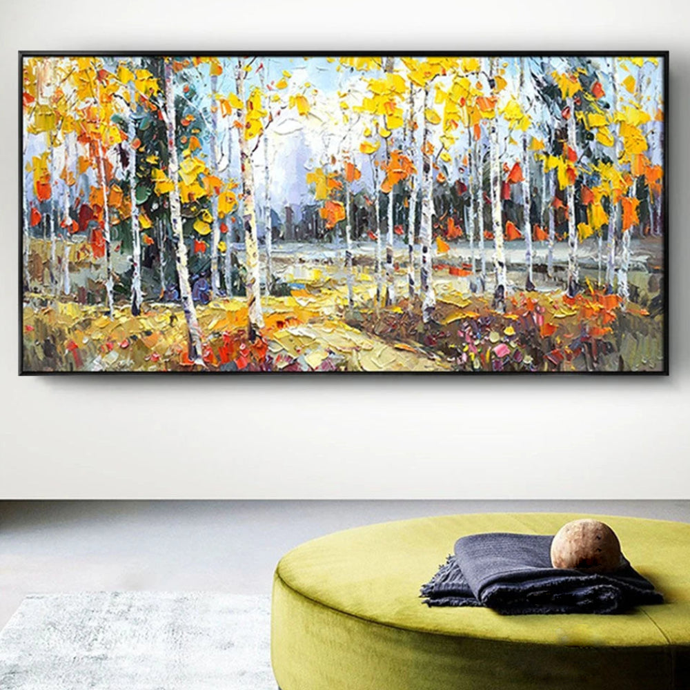 Room mockup showing slender white birch trunks beneath yellow and orange autumn leaves with textured warm foliage on the forest floor.