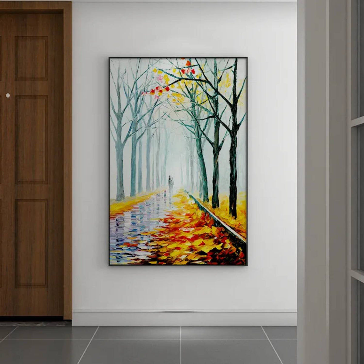Room mockup. A path recedes between bare dark trees, with orange and yellow fallen leaves and a pale misty blue-green distance.