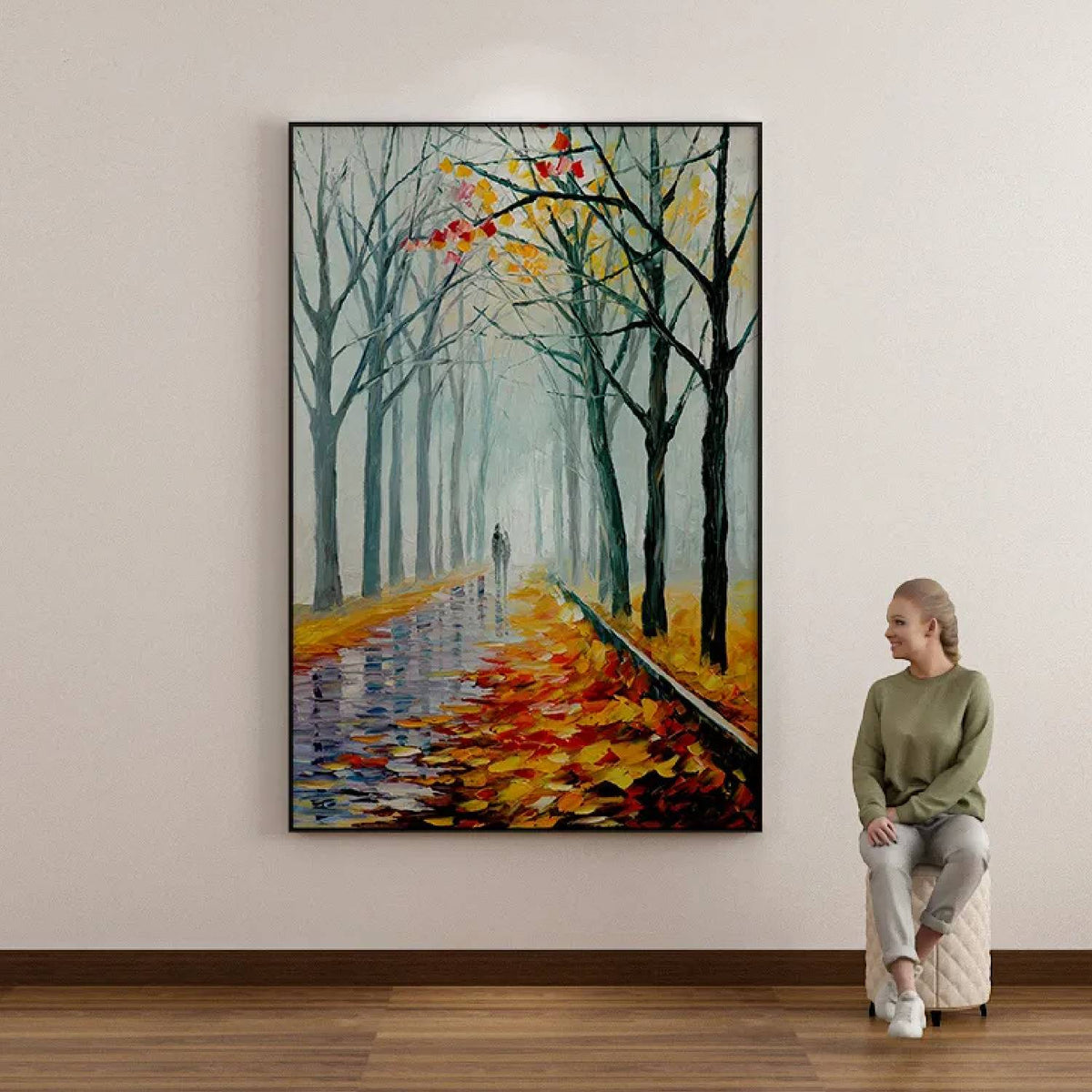 Room mockup. A path recedes between bare dark trees, with orange and yellow fallen leaves and a pale misty blue-green distance.