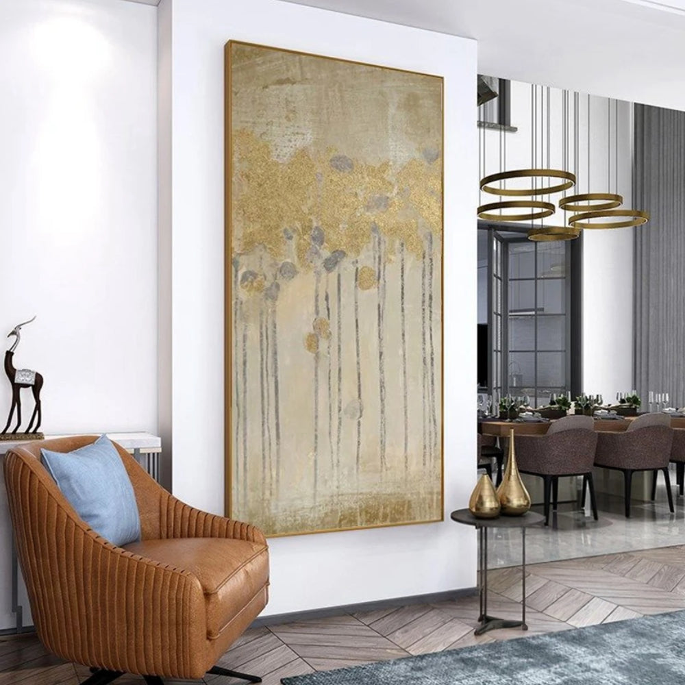 Room mockup showing gold-coloured flower heads on long thin dark stems over a softly textured beige and grey background.