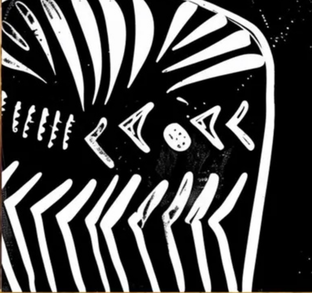 Detail of a fan-shaped crown and white geometric markings on black.