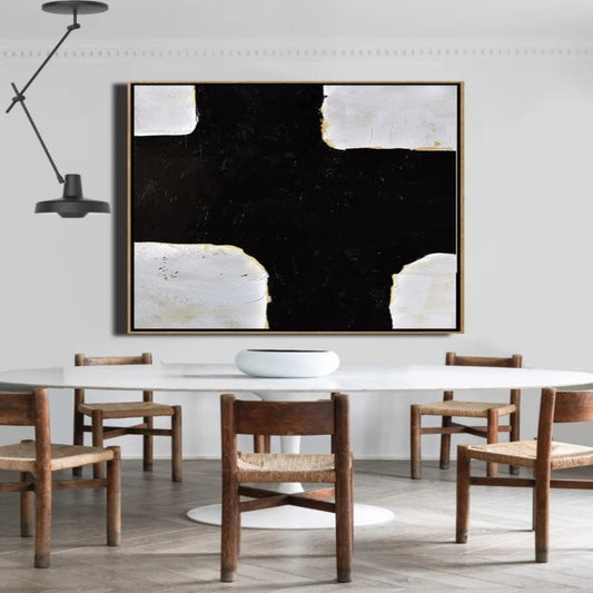 Room mockup. A broad irregular black cross fills the centre, bordered by textured white corner blocks and fine gold-coloured edges.