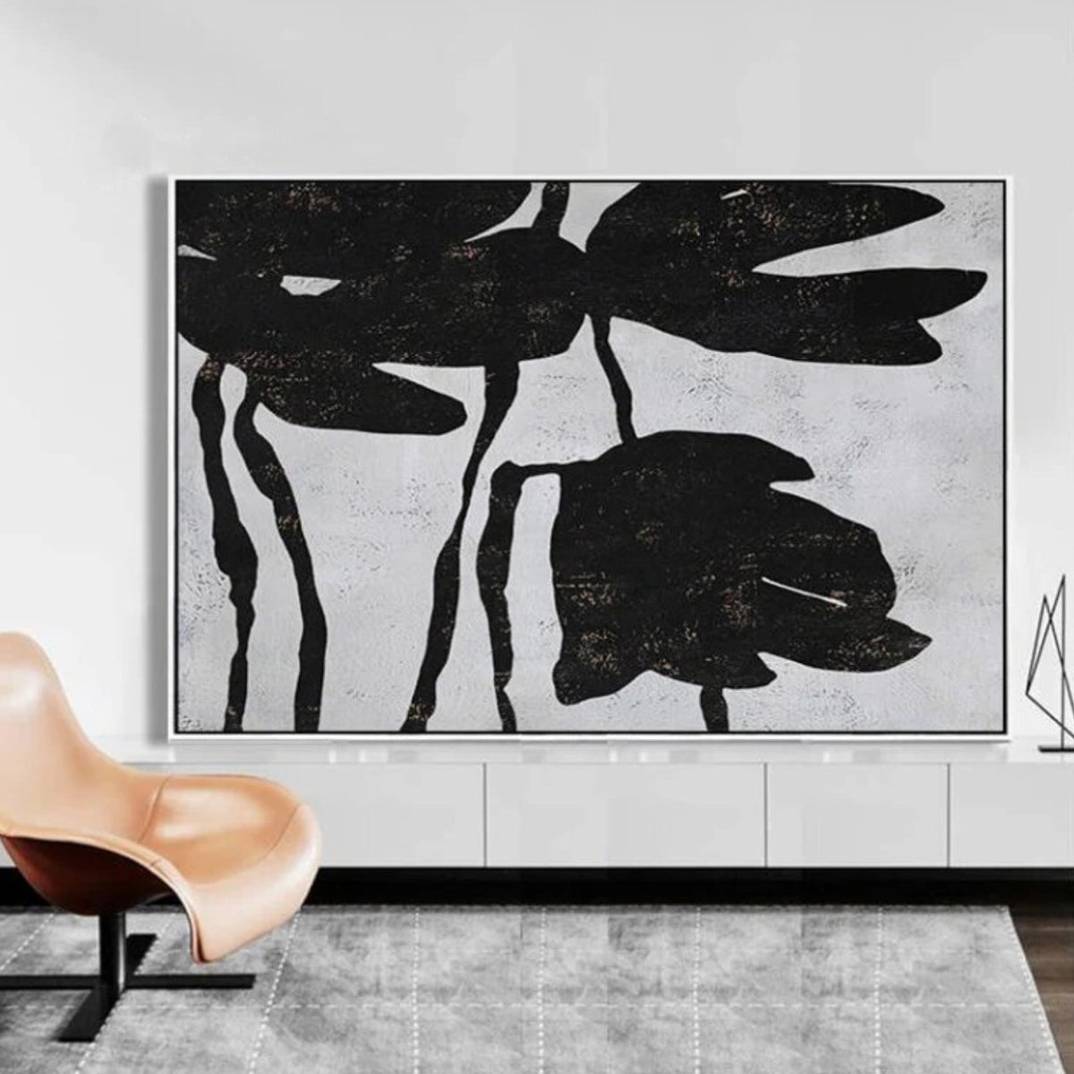 Room mockup. Large black flower silhouettes with drooping petals and thin stems on a pale grey textured background.