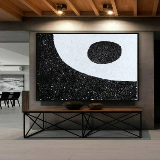 Room mockup. A black oval sits in a broad white curved field above a densely textured black lower area.