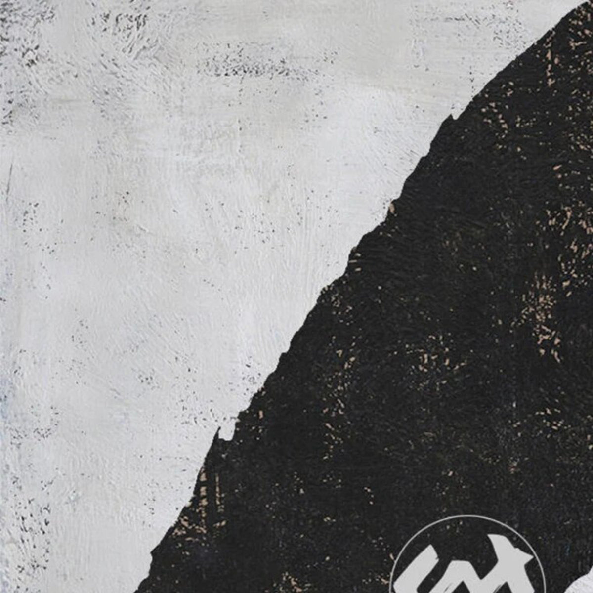 Close-up. Rounded black rectangle, oval and short vertical shapes on a pale grey textured background.