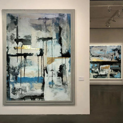 Room mockup showing black vertical drips and horizontal marks over pale grey-white fields with a blue band and small gold-coloured accents.