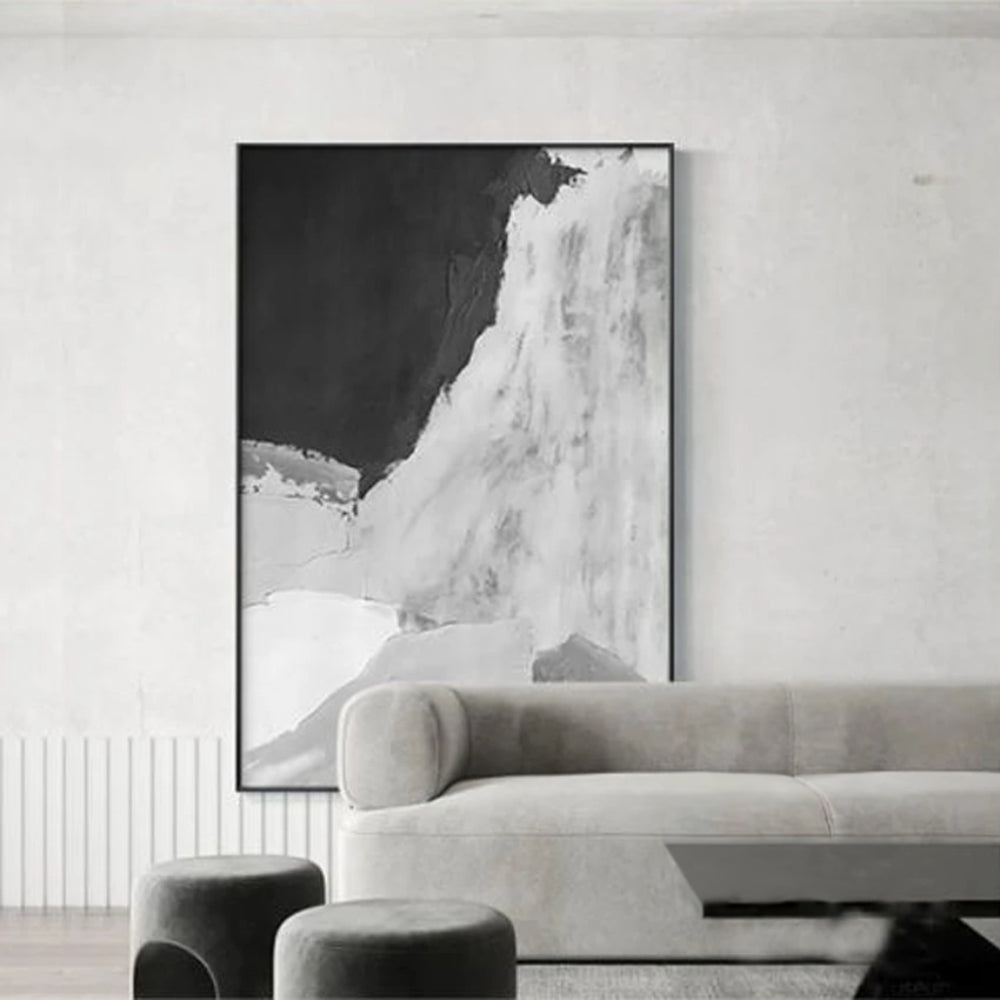 Room mockup showing monochrome abstract with a large black upper field and sweeping textured white and pale grey lower forms.