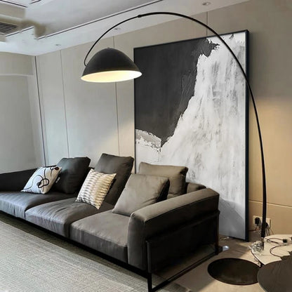 Room mockup showing monochrome abstract with a large black upper field and sweeping textured white and pale grey lower forms.