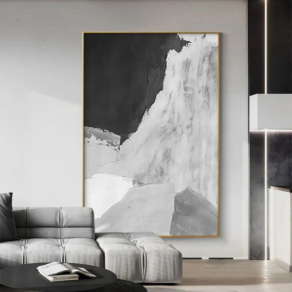 Room mockup showing monochrome abstract with a large black upper field and sweeping textured white and pale grey lower forms.