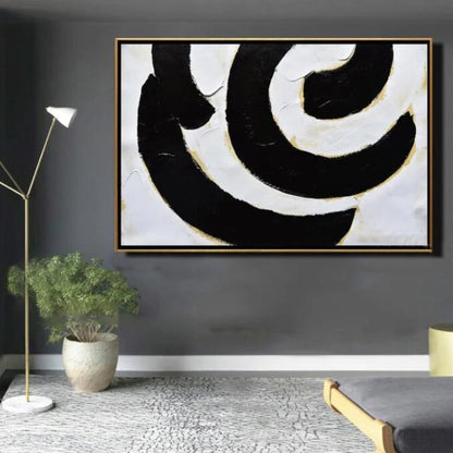 Room mockup. Broad black and white curved bands with fine gold-coloured edges forming an off-centre swirling composition.