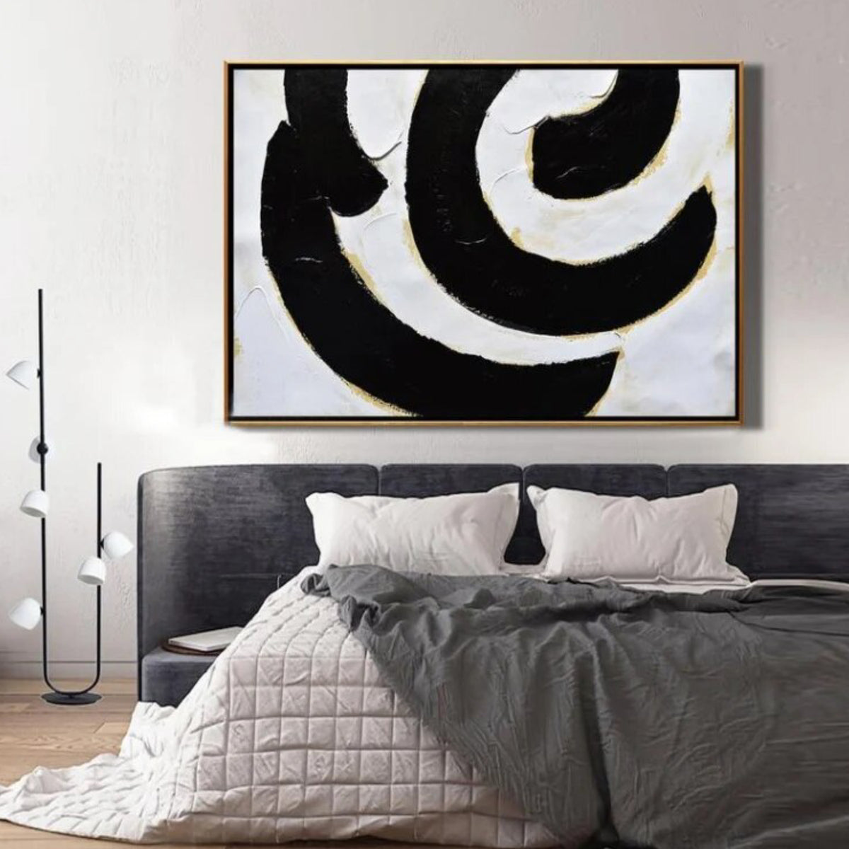 Room mockup. Broad black and white curved bands with fine gold-coloured edges forming an off-centre swirling composition.