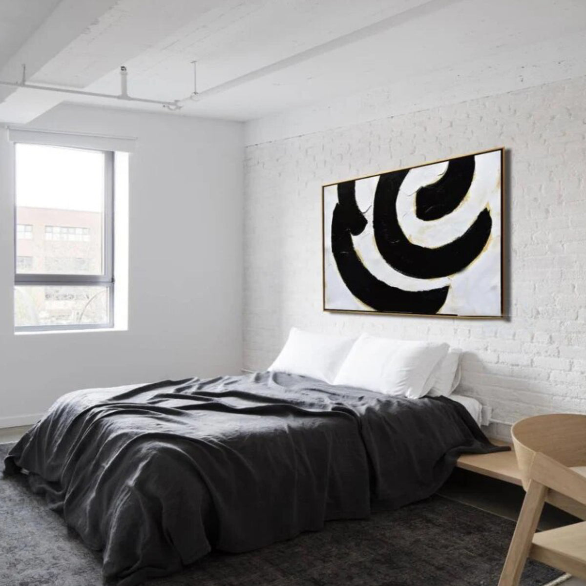 Room mockup. Broad black and white curved bands with fine gold-coloured edges forming an off-centre swirling composition.