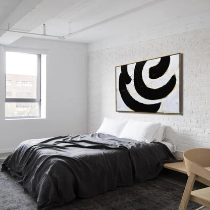 Room mockup. Broad black and white curved bands with fine gold-coloured edges forming an off-centre swirling composition.