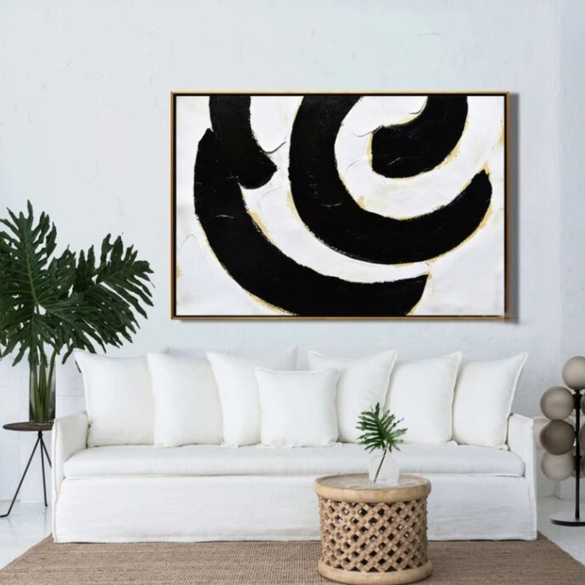Room mockup. Broad black and white curved bands with fine gold-coloured edges forming an off-centre swirling composition.