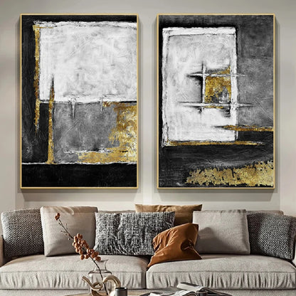 Room mockup showing two textured abstract panels with black, white and grey geometric fields and gold-coloured accents.
