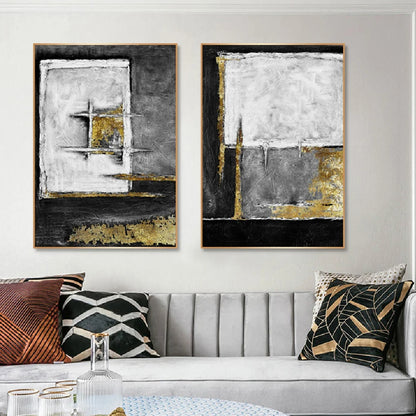 Room mockup showing two textured abstract panels with black, white and grey geometric fields and gold-coloured accents.