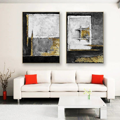 Room mockup showing two textured abstract panels with black, white and grey geometric fields and gold-coloured accents.
