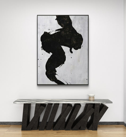 Room mockup. A thick winding black brushstroke with ragged edges and small splashes on pale grey.