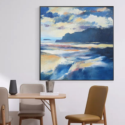Room mockup showing blue and cream coastal landscape with a dark headland, pale waves and layered clouds above.