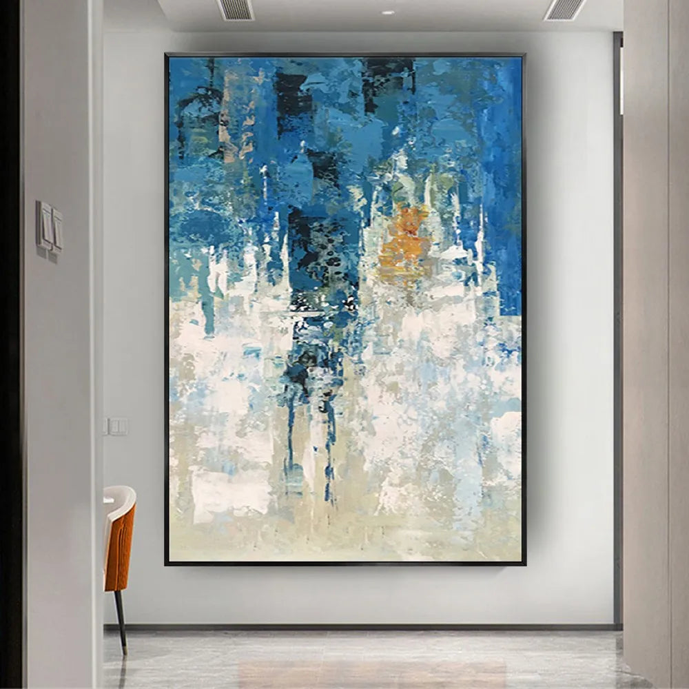 Room mockup showing textured abstract painting with deep blue and cream fields, a dark central band and small ochre accents.