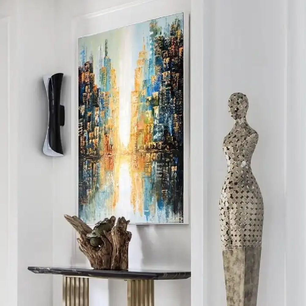 Room mockup showing abstract blue and dark navy city buildings with gold-coloured accents flanking a bright cream central passage and reflections.