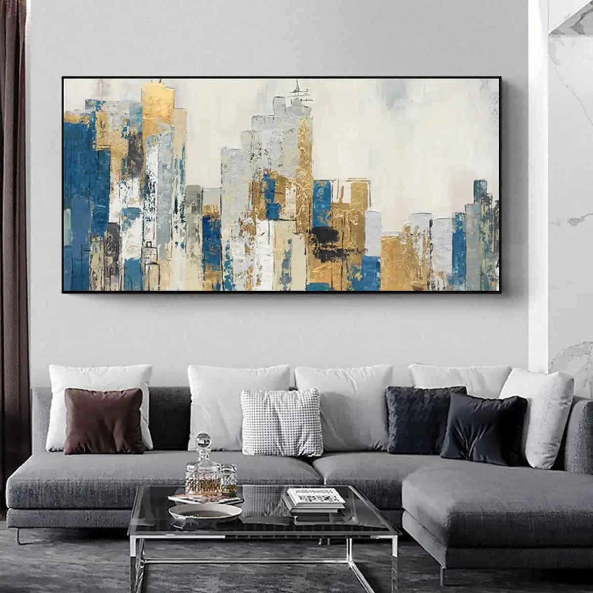 Room mockup showing abstract city buildings in blue, grey, cream and gold-coloured blocks beneath a pale sky.