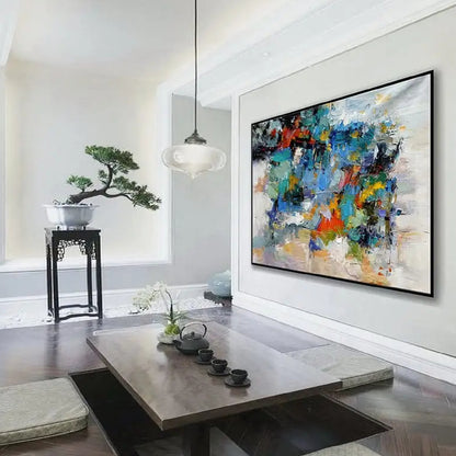 Room mockup. Layered blue, green, orange, yellow and black patches break across pale grey and white textured strokes.