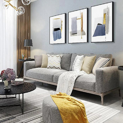 Room mockup showing three minimalist white panels with blue-grey geometric shapes, narrow gold-coloured strips and fine black lines.