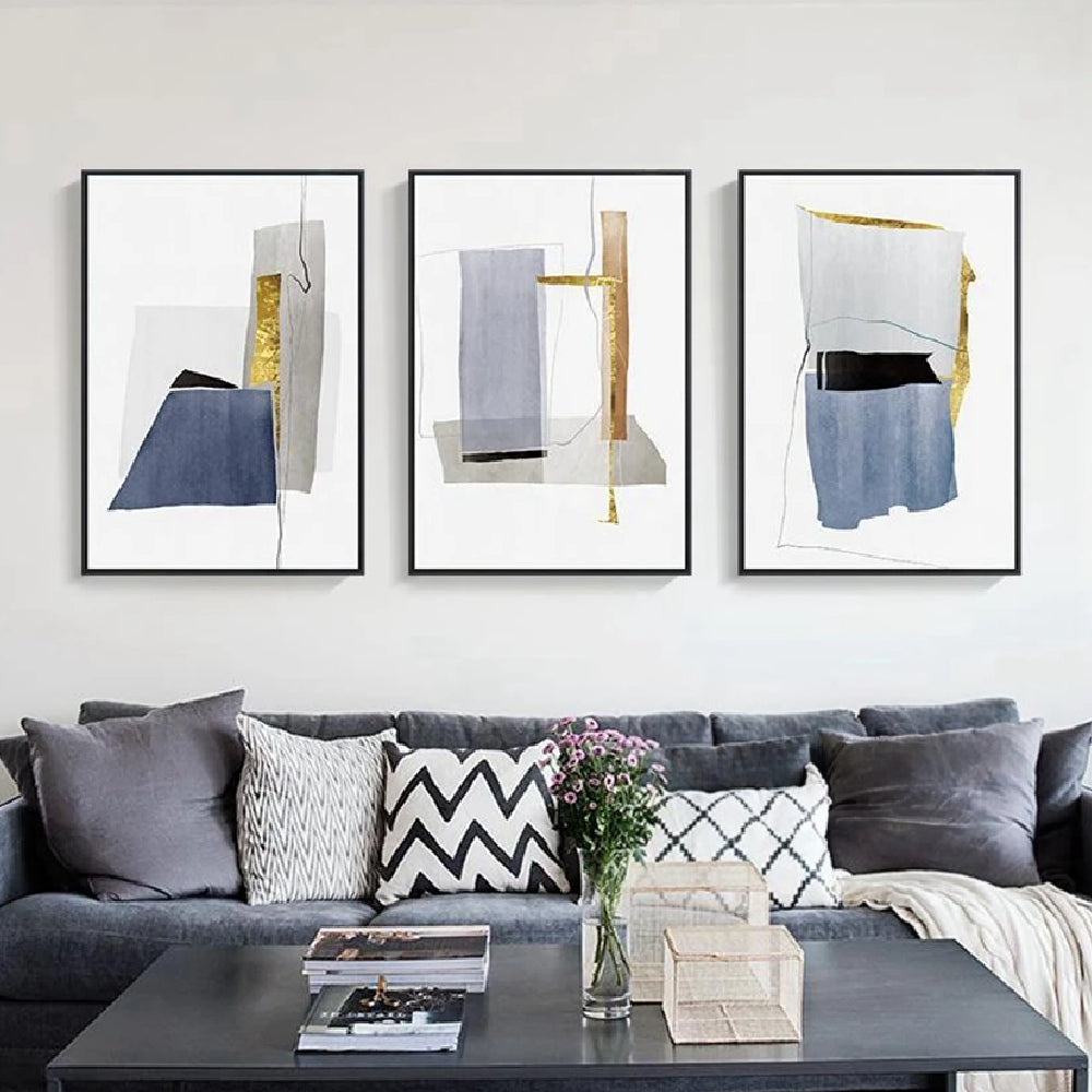 Room mockup showing three minimalist white panels with blue-grey geometric shapes, narrow gold-coloured strips and fine black lines.
