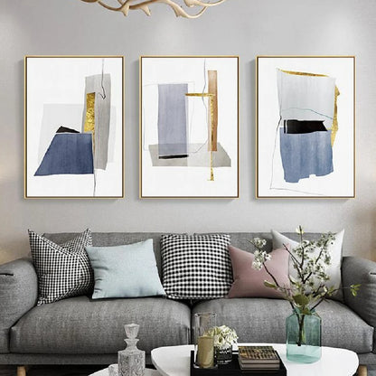 Room mockup showing three minimalist white panels with blue-grey geometric shapes, narrow gold-coloured strips and fine black lines.