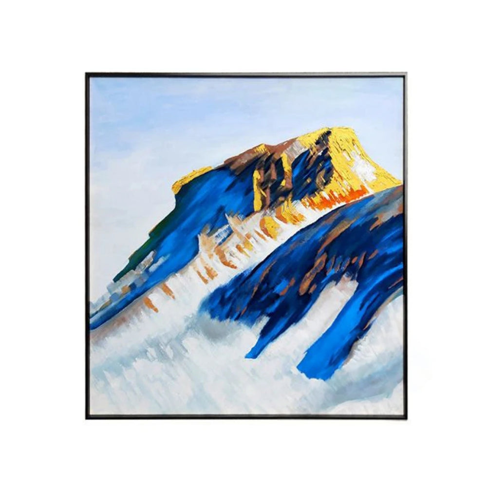 Deep blue mountain slopes and ochre peaks above broad pale white areas beneath a light sky.