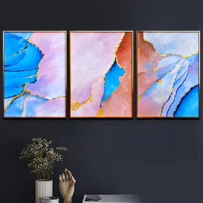 Room mockup showing three abstract panels with vivid blue, pale pink and coral flowing fields divided by thin gold-coloured lines.
