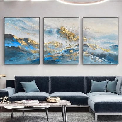 Room mockup showing three blue and white abstract mountain-like landscapes with gold-coloured textured peaks and sweeping water-like bands.