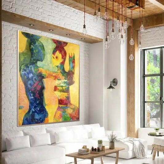 Room mockup. Two stylised embracing figures formed from blue, green, orange and red shapes on a bright yellow background.