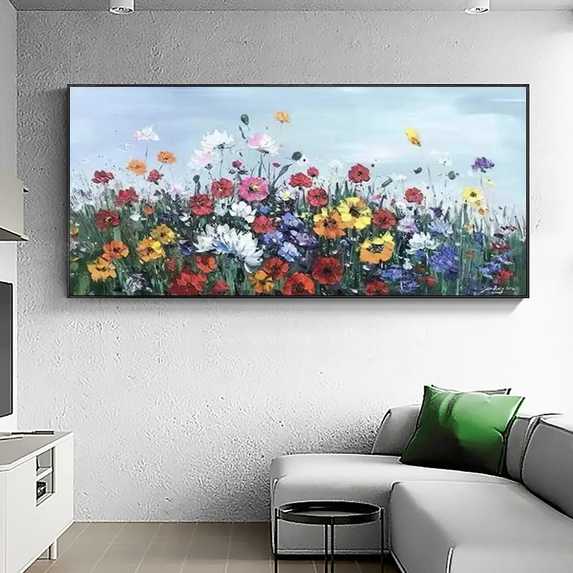 Room mockup showing dense red, yellow, white and purple meadow flowers on green stems beneath a pale blue sky.