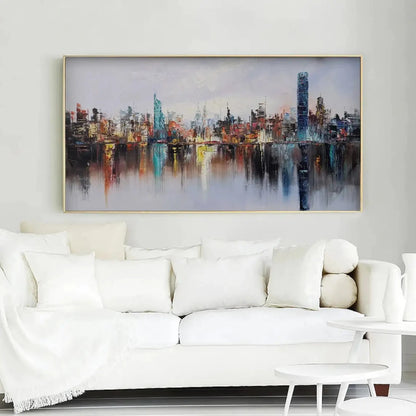 Room mockup showing colourful city skyline with a tall blue tower and long vertical reflections in calm water beneath a pale sky.